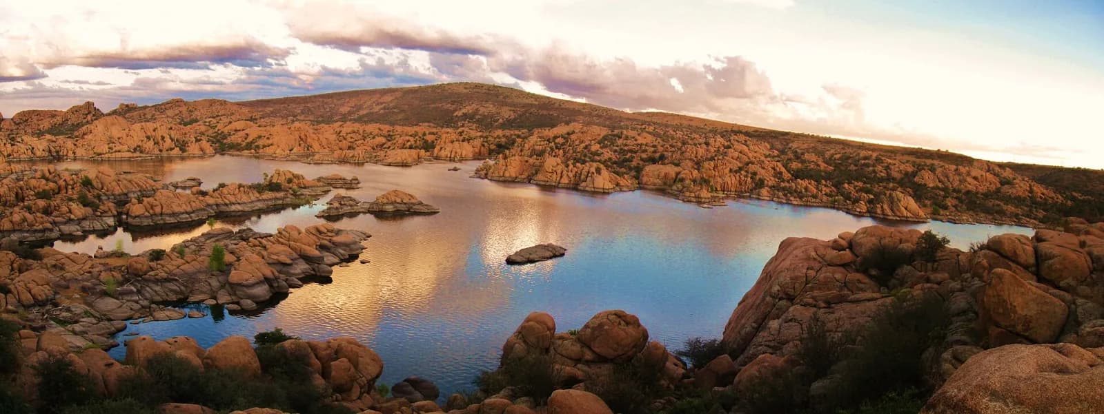 Blue water winding through the rounded granite formations at Watson Lake